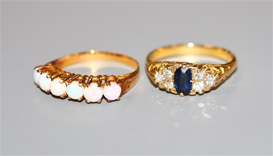 An 18ct, sapphire and diamond ring and a yellow metal and six stone white opal half hoop ring.